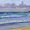 waves on to a golden sand beach
